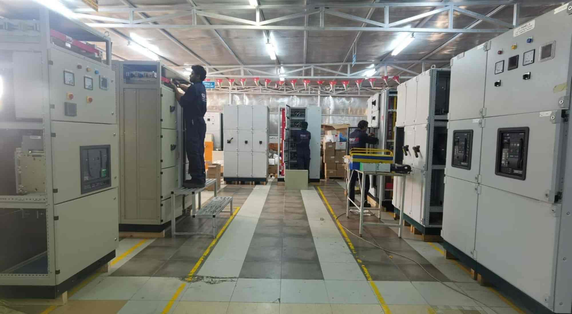 A line-up of low-voltage switchgear cubicles in a plant electrical room